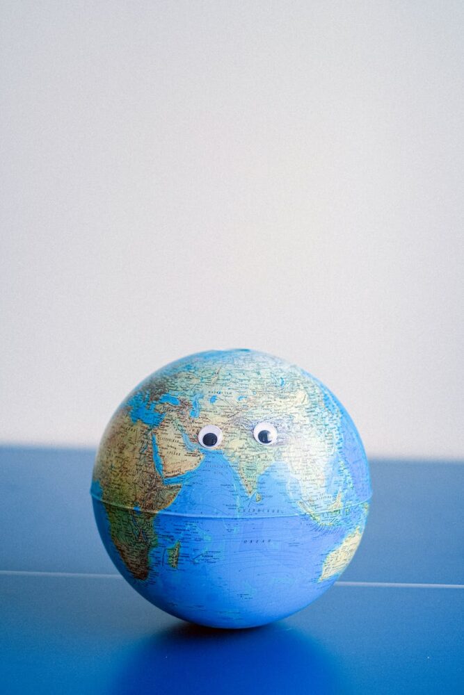 sphere shaped miniature of earth with googly eyes